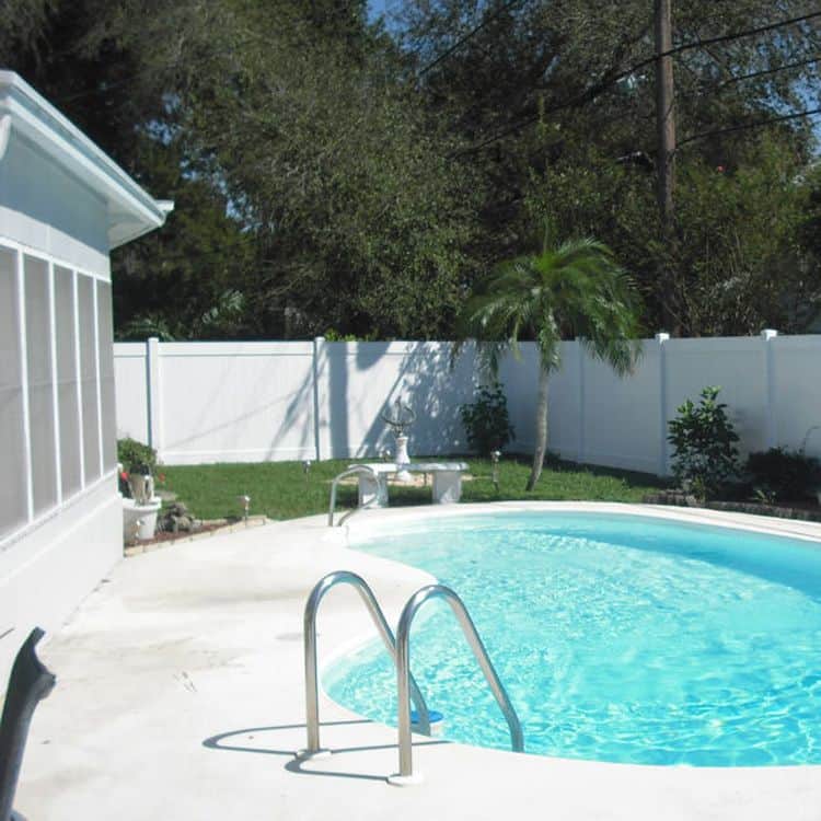 Pool in front of vinyl fence