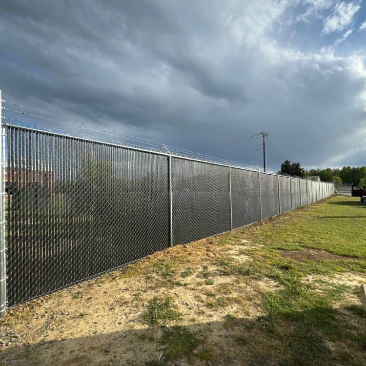 https://www.superiorfenceandrail.com/wp-content/uploads/2024/11/chain-link-fence-with-privacy-slats-chain-link-privacy-fence.jpg