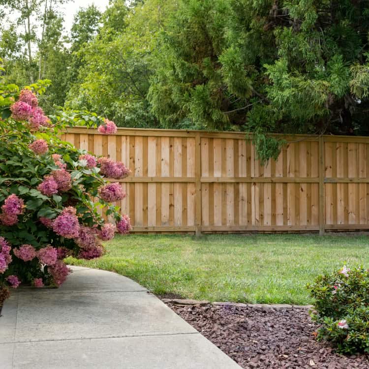 https://www.superiorfenceandrail.com/wp-content/uploads/2025/02/fence-installers-around-me-wood-board-on-board-garden-fence.jpg